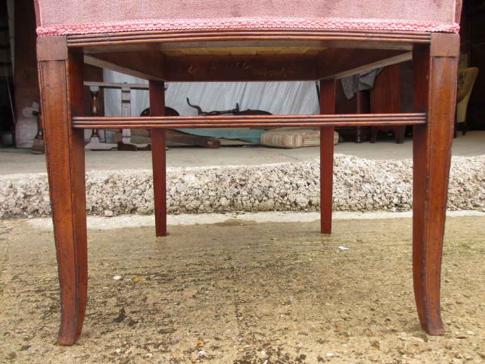 A pair of 19th-century mahogany dining chairs featuring upholstered dusty pink velvet rectangular backs and seats with reeded wooden legs. View IX