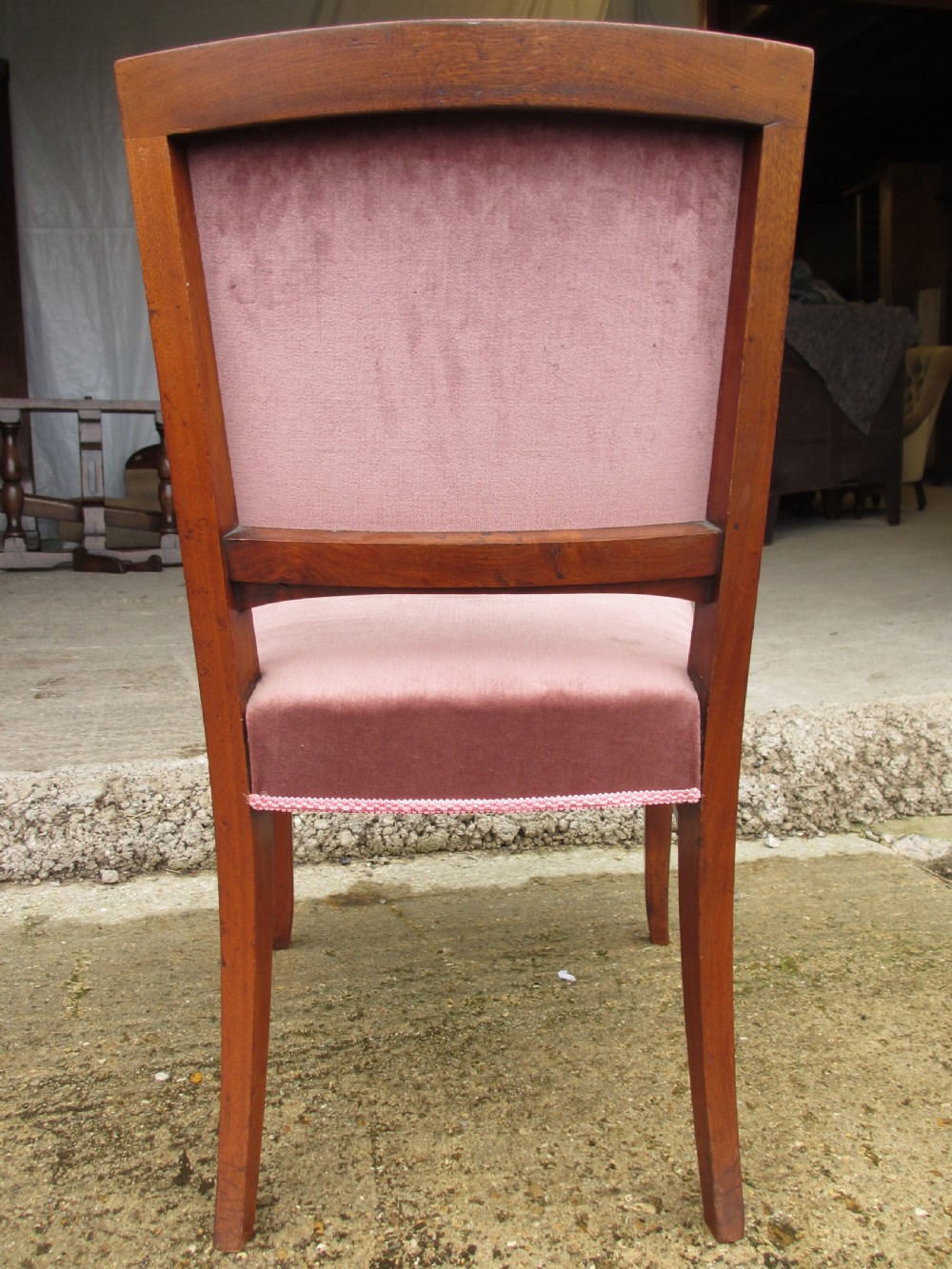 A pair of 19th-century mahogany dining chairs featuring upholstered dusty pink velvet rectangular backs and seats with reeded wooden legs. View XI