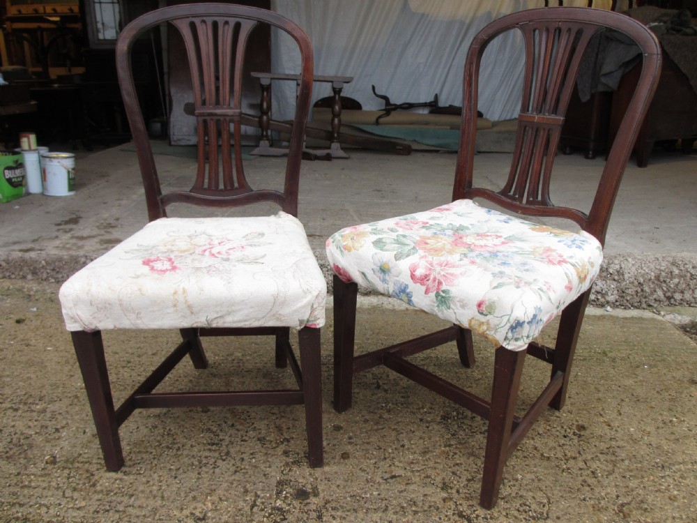 A pair of 19th-century mahogany dining chairs featuring openwork pierced vase splats, square legs with stretchers, and floral drop-in fabric seats. View II