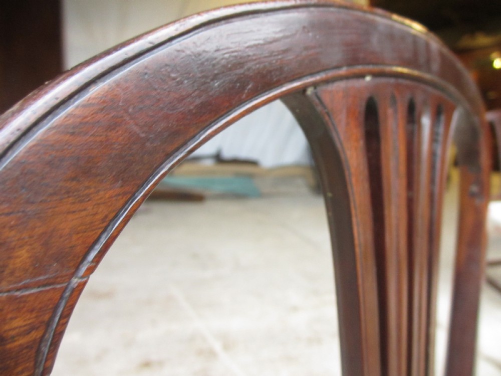 A pair of 19th-century mahogany dining chairs featuring openwork pierced vase splats, square legs with stretchers, and floral drop-in fabric seats. View VII