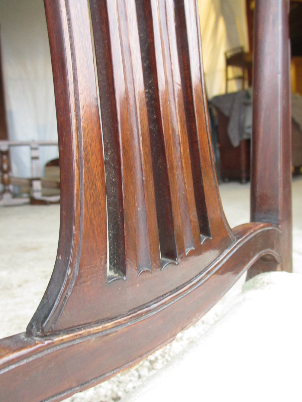 A pair of 19th-century mahogany dining chairs featuring openwork pierced vase splats, square legs with stretchers, and floral drop-in fabric seats. View VIII