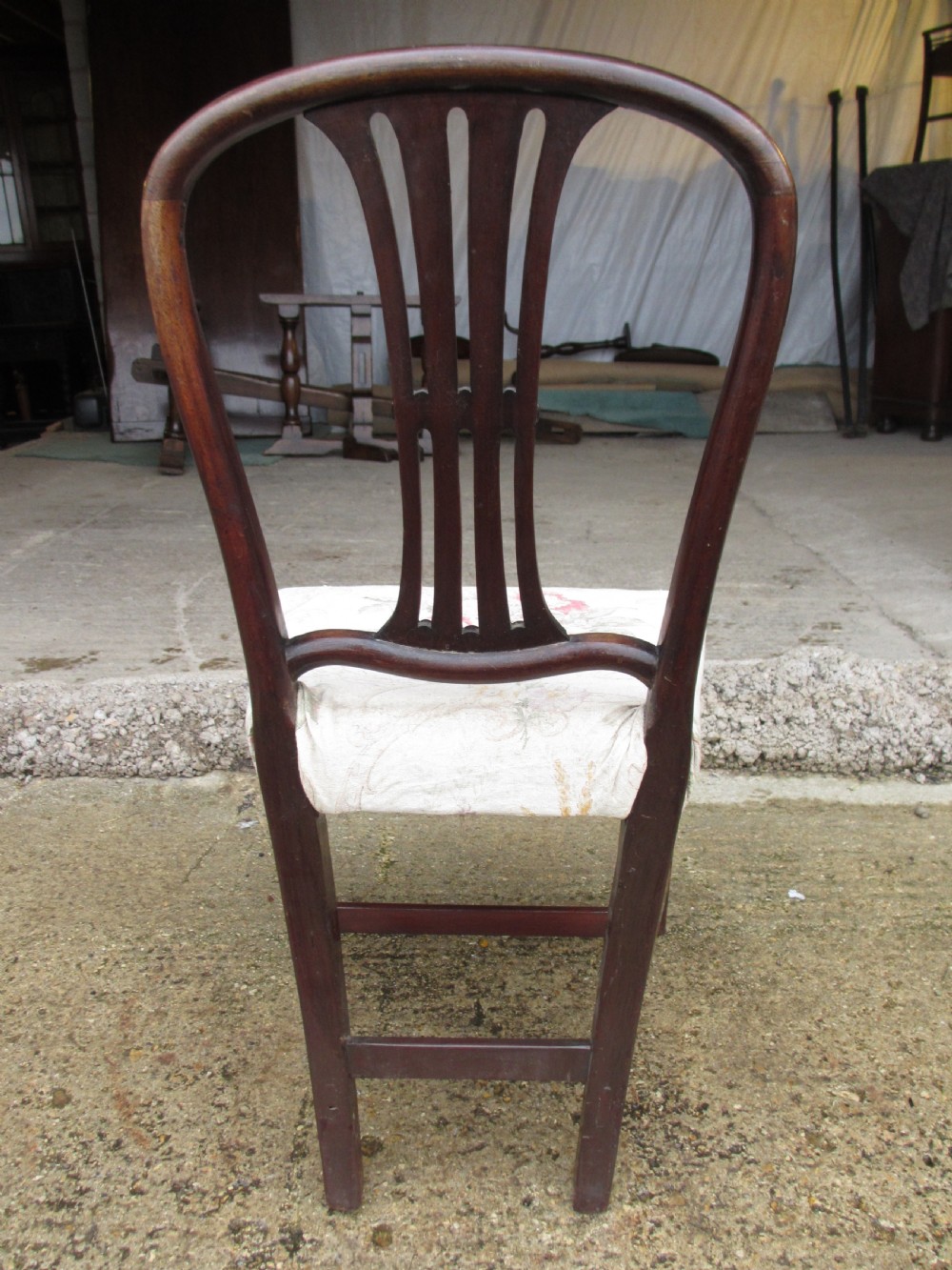 A pair of 19th-century mahogany dining chairs featuring openwork pierced vase splats, square legs with stretchers, and floral drop-in fabric seats. View XI