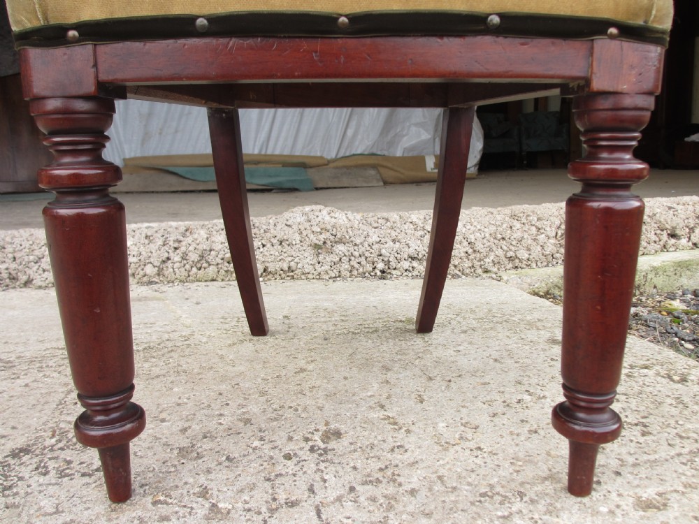 A set of four 19th-century mahogany dining chairs with curved bar backs, turned front legs, and cushioned tan velvet seats. View X