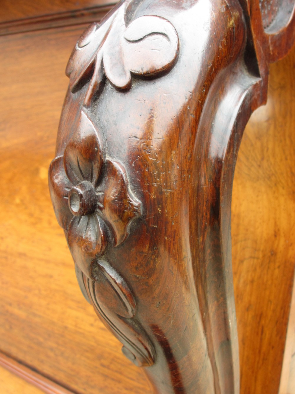 A Victorian rosewood davenport secretaire desk featuring an open black leather-lined writing slope, an upper gallery with drawers and pigeonholes, side drawers, and carved cabriole supports. View VIII