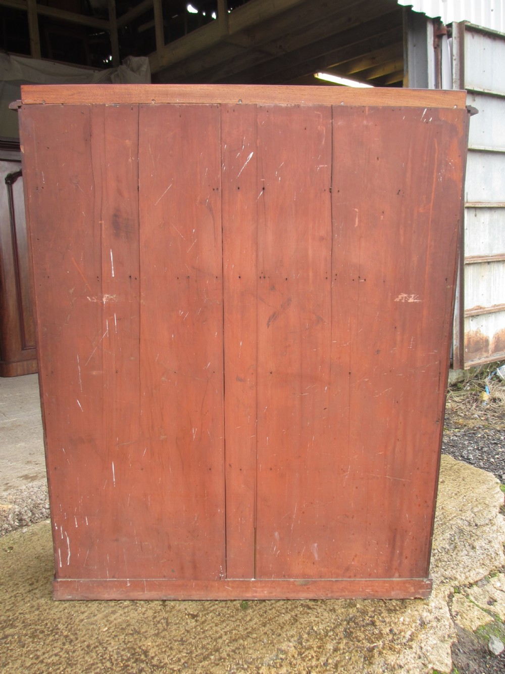 A tall 19th-century mahogany waterfall bookcase featuring six graduating open shelves with green fabric lining and a shaped gallery top. View IX