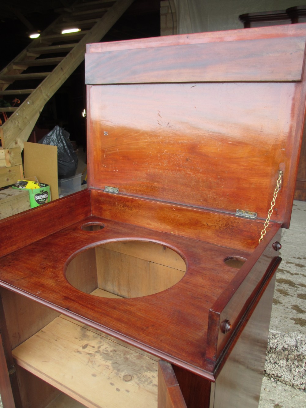 A Victorian flame mahogany washstand cupboard with a single panelled door, wooden knob handle, and plinth base. View VIII
