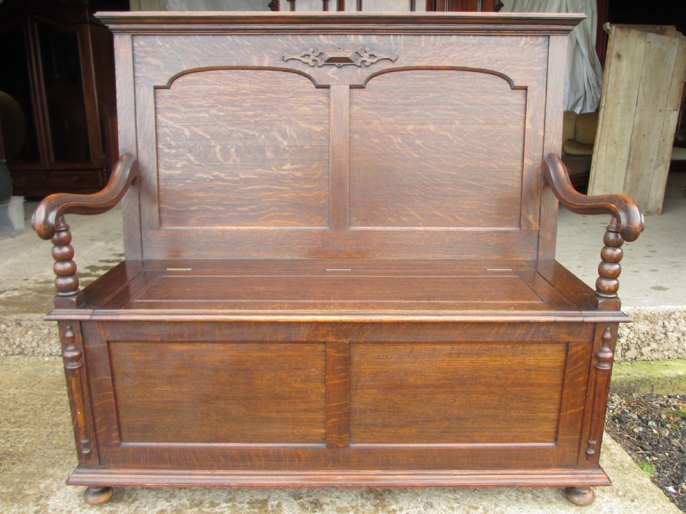 victorian oak panelled box settle with scroll and bobbin turned arms