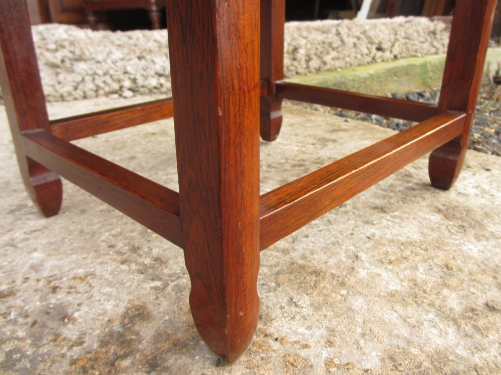 A set of four graduating rosewood side tables nested together, featuring relief-carved lotus friezes and straight legs. View IX