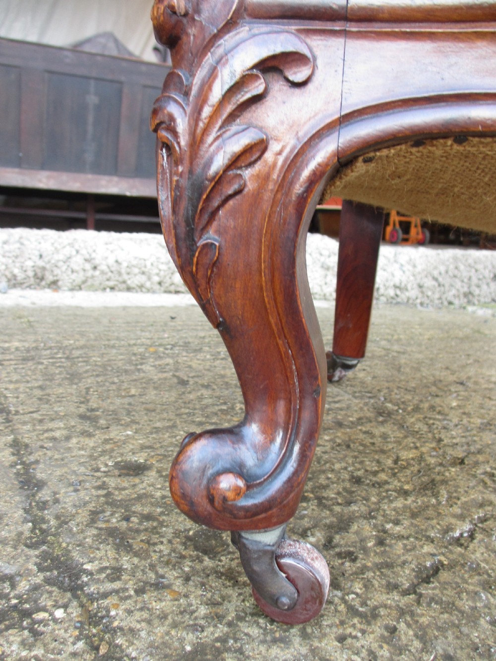 A Victorian carved mahogany prie-dieu chair featuring a tall padded backrest and low seat upholstered in crimson velvet with carved cabriole front legs. View VII