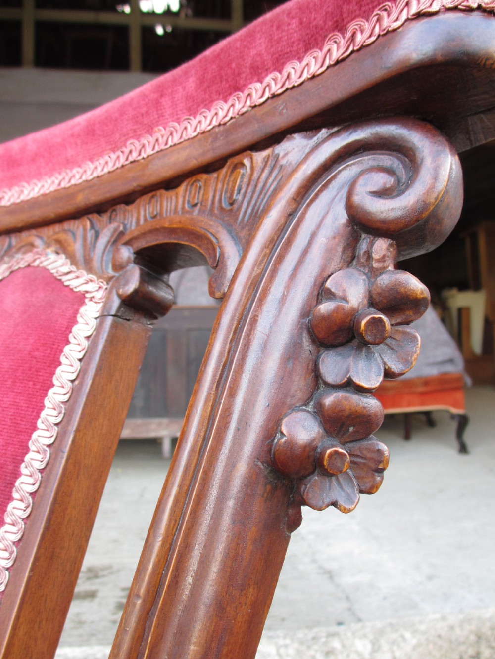 A Victorian carved mahogany prie-dieu chair featuring a tall padded backrest and low seat upholstered in crimson velvet with carved cabriole front legs. View XI