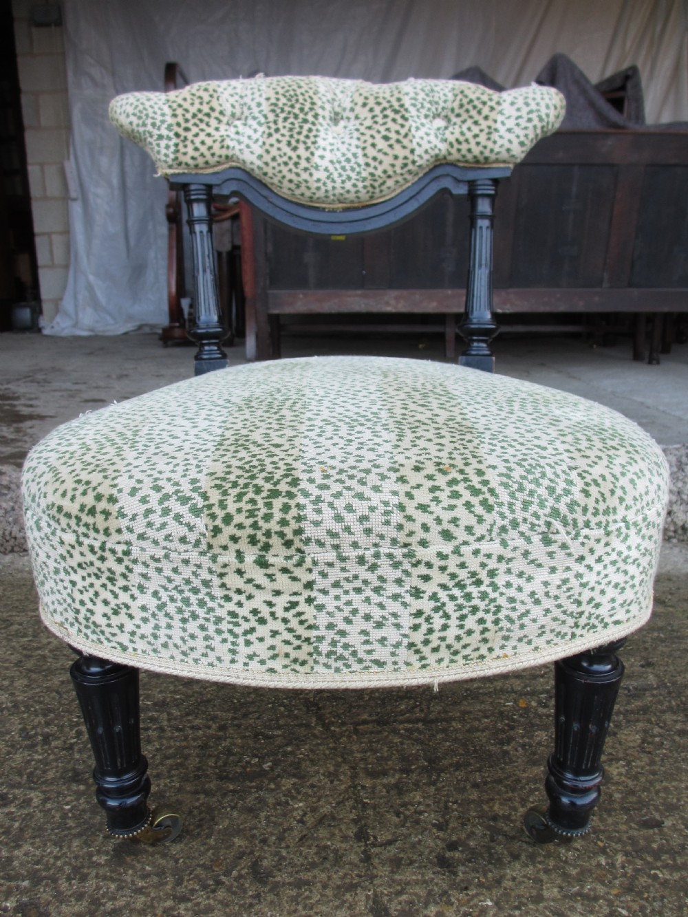 19th century ebonised and upholstered nursing chair with brass castors