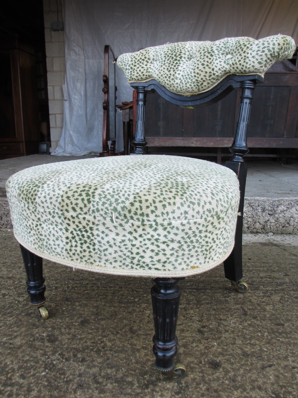 19th century ebonised and upholstered nursing chair with brass castors View II