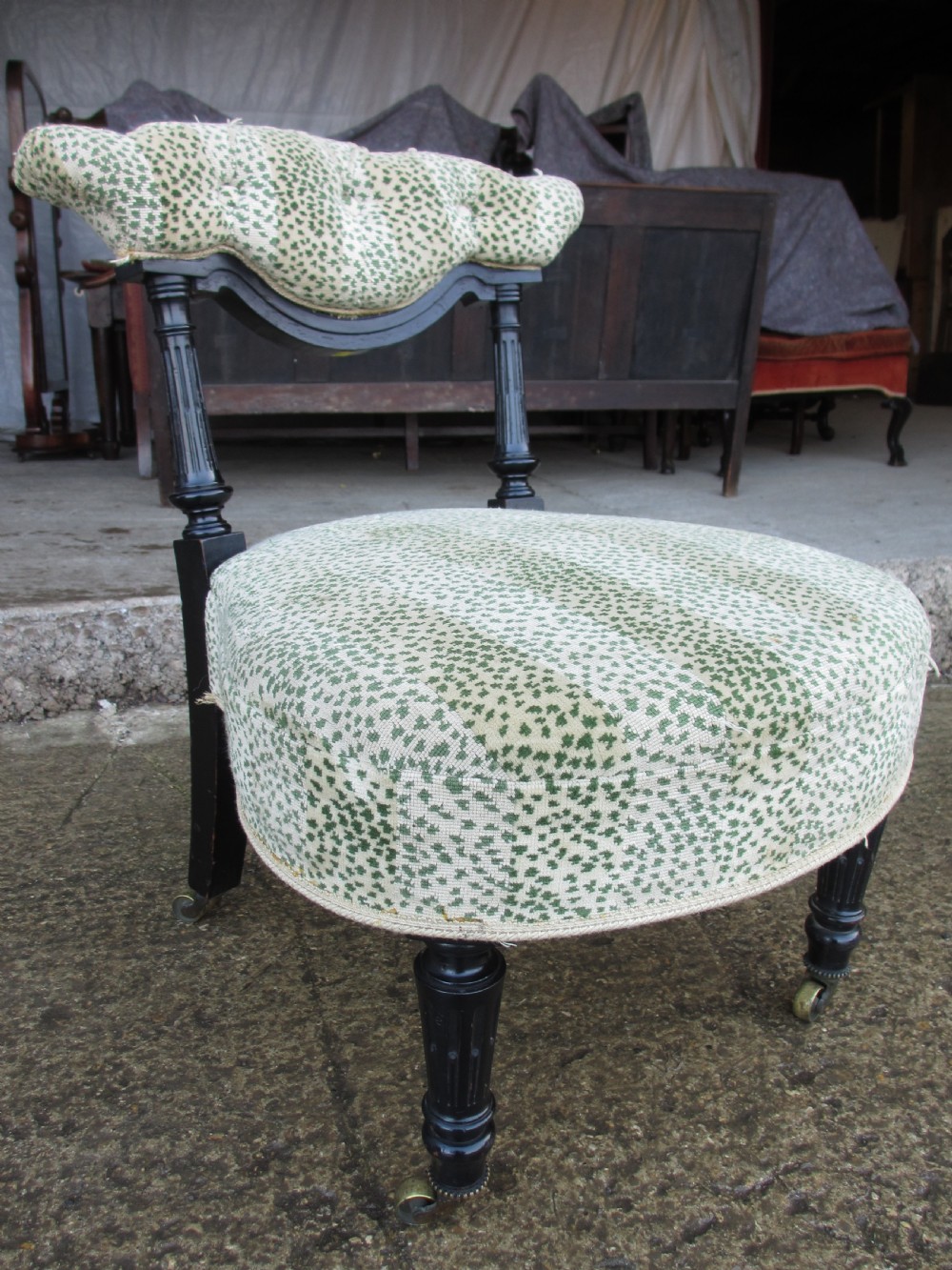 19th century ebonised and upholstered nursing chair with brass castors View III