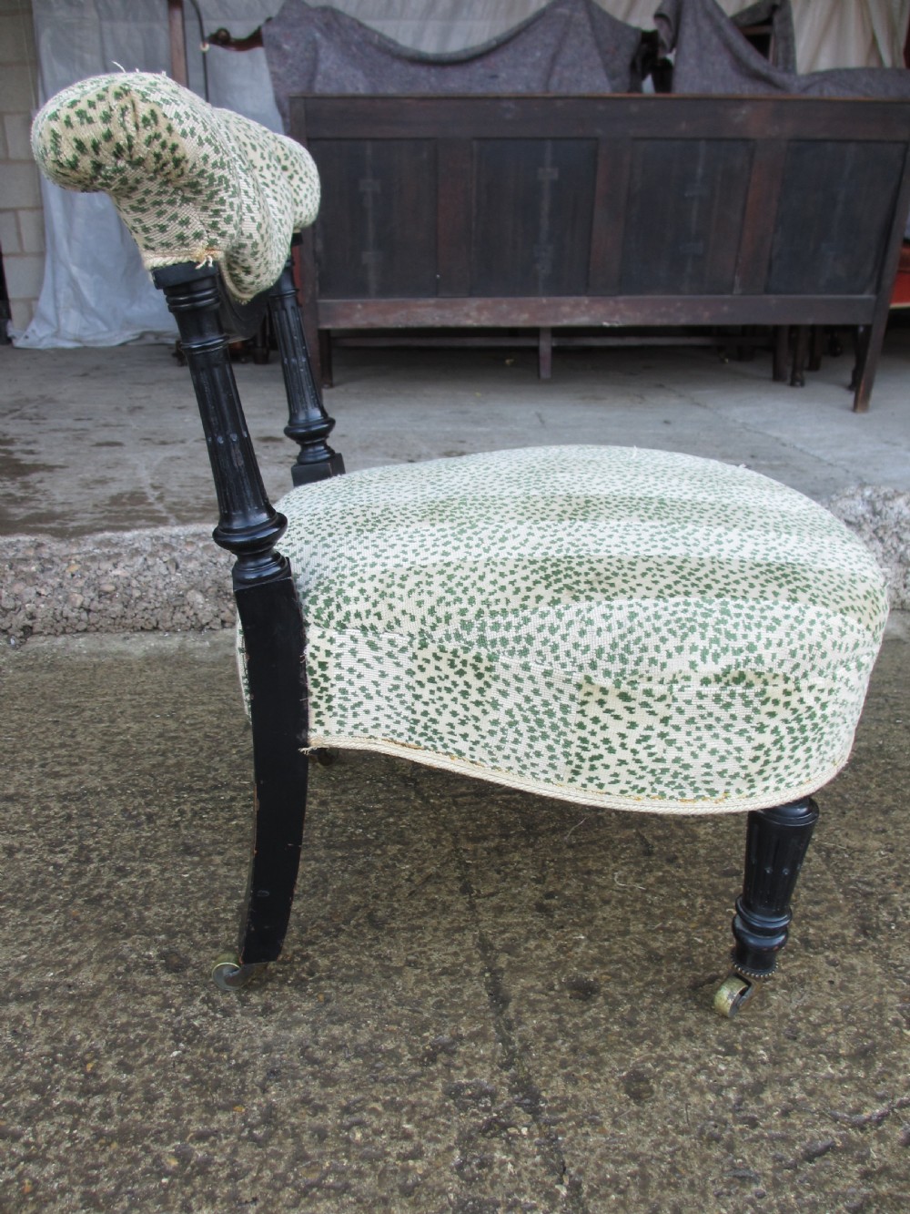 19th century ebonised and upholstered nursing chair with brass castors View XII