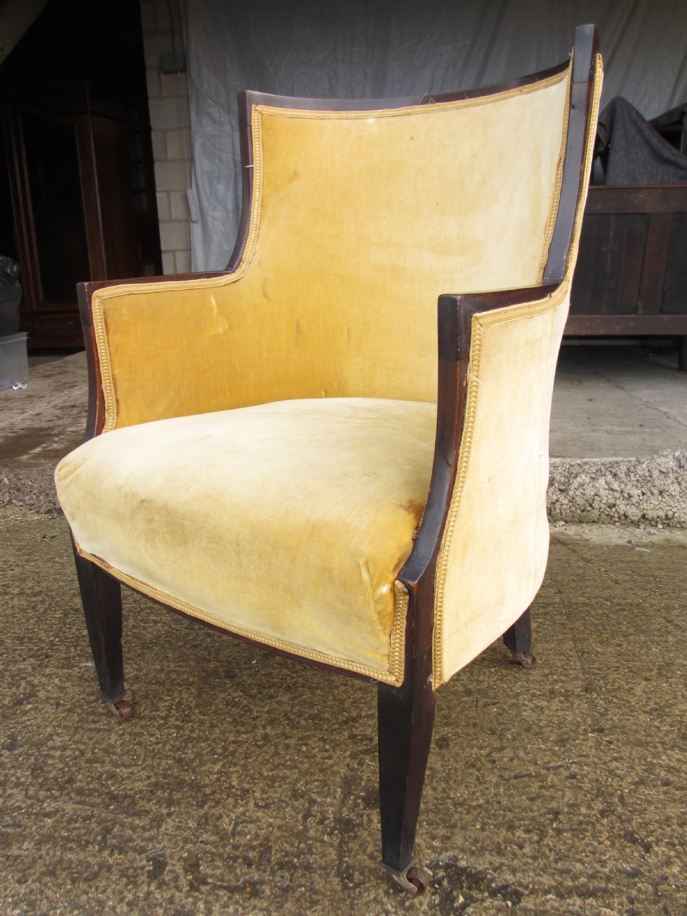 A 19th-century mahogany framed tub armchair featuring yellow velvet upholstery and square tapered legs. View II