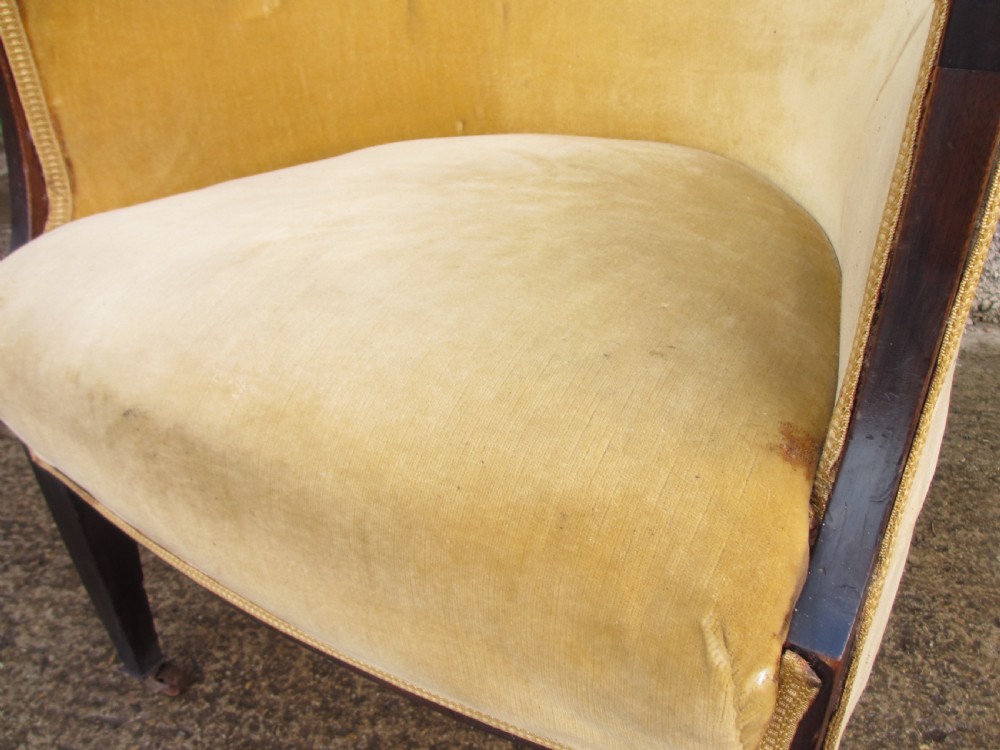 A 19th-century mahogany framed tub armchair featuring yellow velvet upholstery and square tapered legs. View V