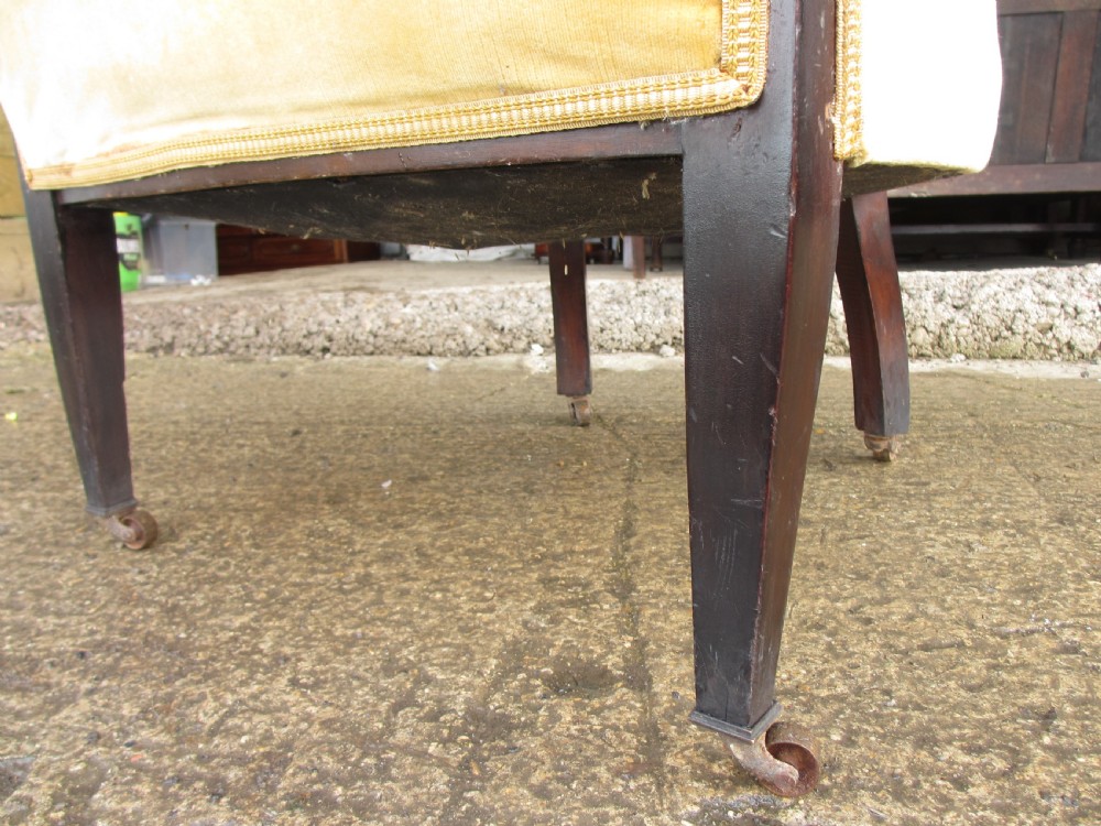 A 19th-century mahogany framed tub armchair featuring yellow velvet upholstery and square tapered legs. View VI