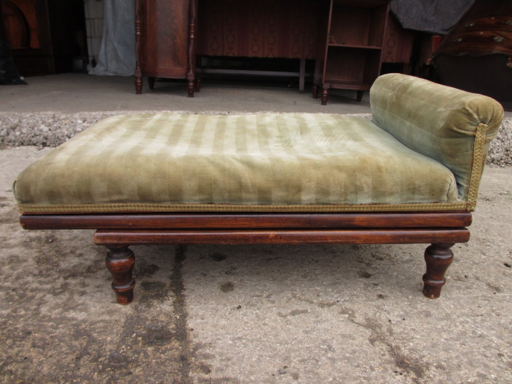 A nineteenth-century beechwood gout stool with an adjustable angled top upholstered in light green striped velvet fabric set upon a dark timber ratchet frame. View II