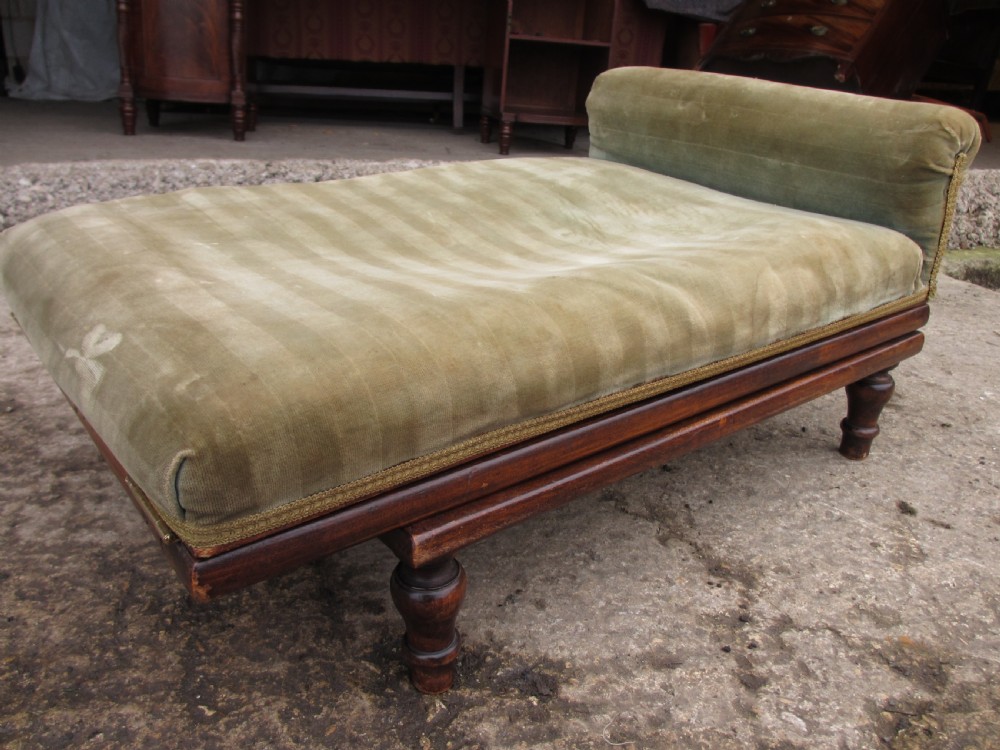 A nineteenth-century beechwood gout stool with an adjustable angled top upholstered in light green striped velvet fabric set upon a dark timber ratchet frame. View III