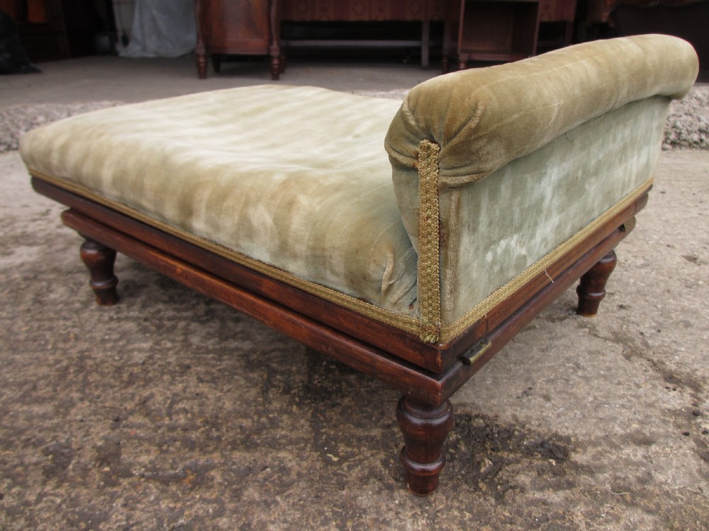 A nineteenth-century beechwood gout stool with an adjustable angled top upholstered in light green striped velvet fabric set upon a dark timber ratchet frame. View IV