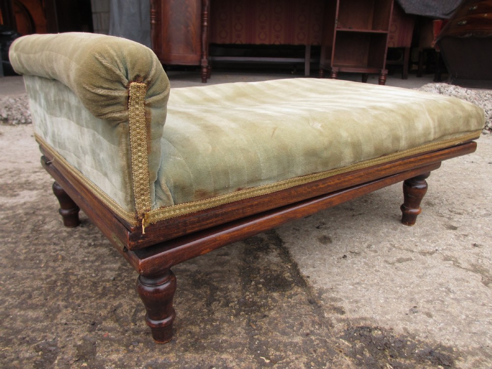 A nineteenth-century beechwood gout stool with an adjustable angled top upholstered in light green striped velvet fabric set upon a dark timber ratchet frame. View V