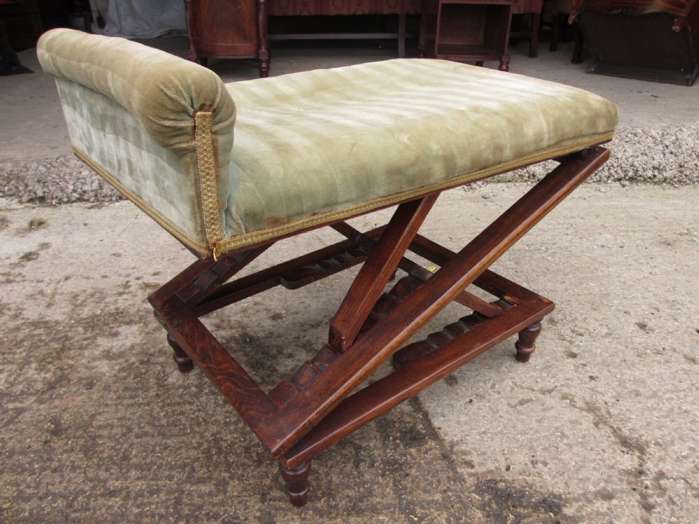 A nineteenth-century beechwood gout stool with an adjustable angled top upholstered in light green striped velvet fabric set upon a dark timber ratchet frame. View VII