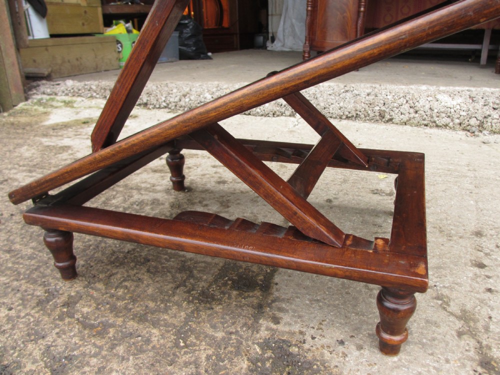 A nineteenth-century beechwood gout stool with an adjustable angled top upholstered in light green striped velvet fabric set upon a dark timber ratchet frame. View IX