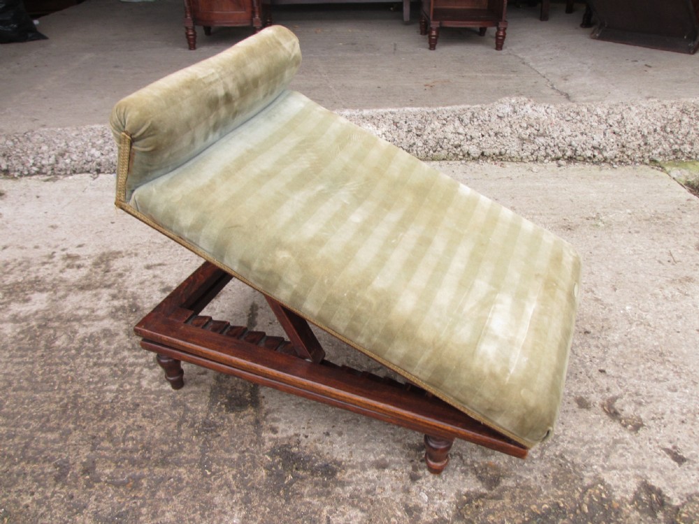 A nineteenth-century beechwood gout stool with an adjustable angled top upholstered in light green striped velvet fabric set upon a dark timber ratchet frame. View XI