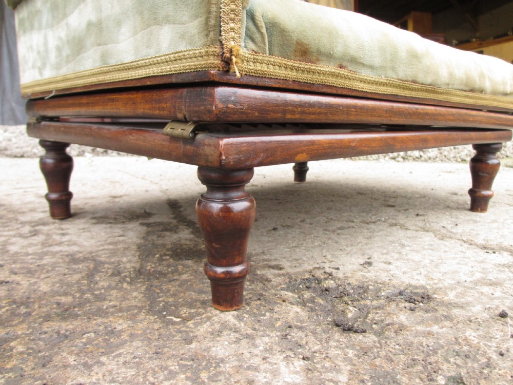 A nineteenth-century beechwood gout stool with an adjustable angled top upholstered in light green striped velvet fabric set upon a dark timber ratchet frame. View XIV