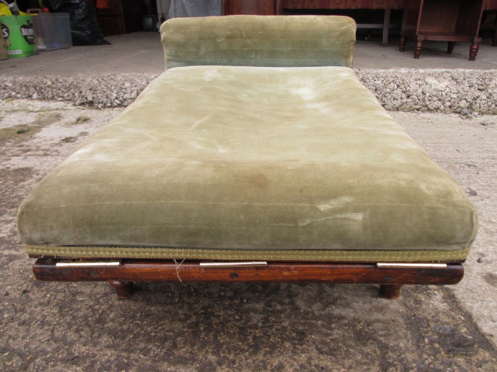 A nineteenth-century beechwood gout stool with an adjustable angled top upholstered in light green striped velvet fabric set upon a dark timber ratchet frame. View XVI