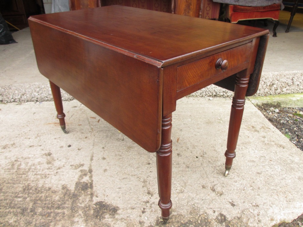 Victorian mahogany Pembroke table with two hinged drop leaves, an end drawer with wooden knobs, and turned legs fitted with brass castors. View III