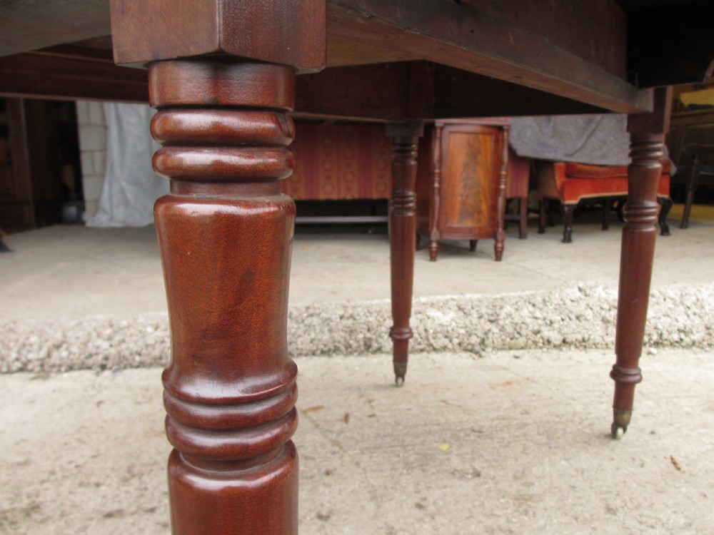 Victorian mahogany Pembroke table with two hinged drop leaves, an end drawer with wooden knobs, and turned legs fitted with brass castors. View VII