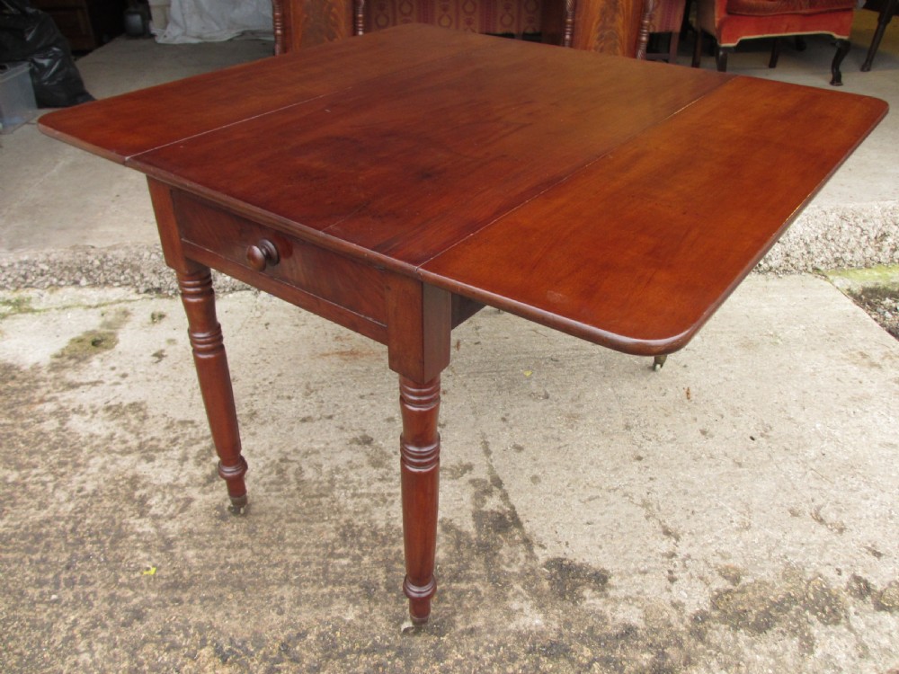 Victorian mahogany Pembroke table with two hinged drop leaves, an end drawer with wooden knobs, and turned legs fitted with brass castors. View VIII