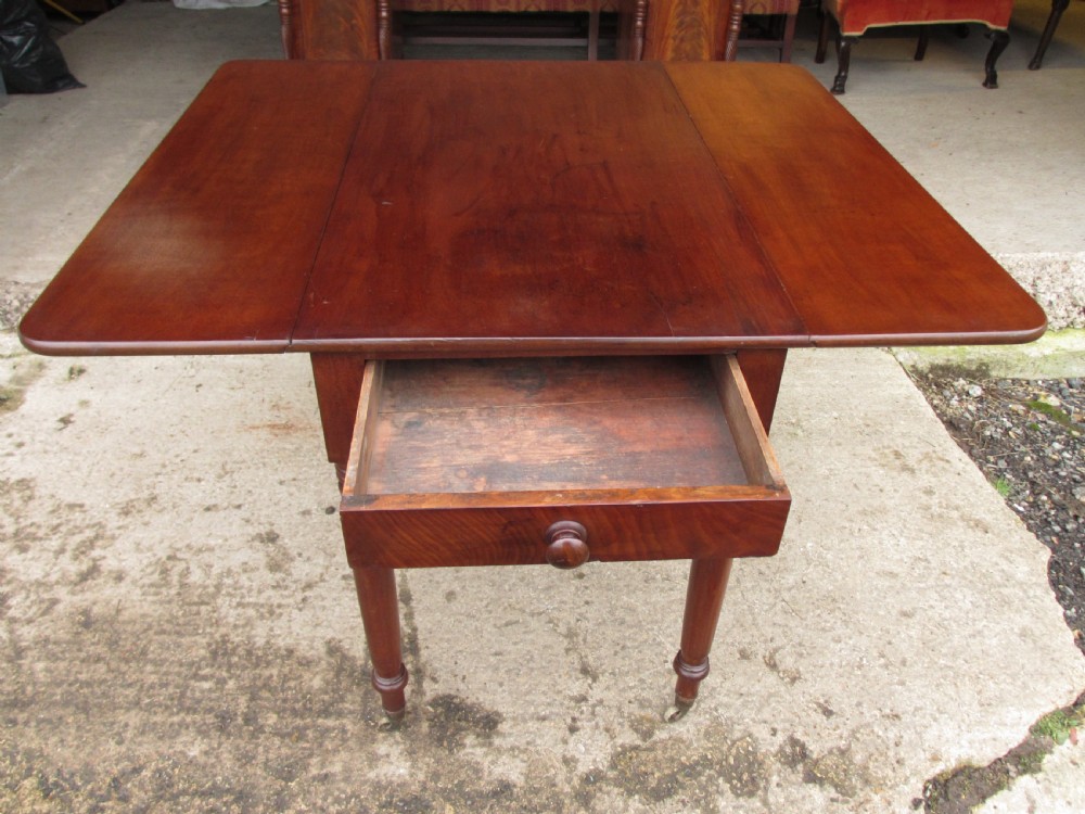 Victorian mahogany Pembroke table with two hinged drop leaves, an end drawer with wooden knobs, and turned legs fitted with brass castors. View XIII