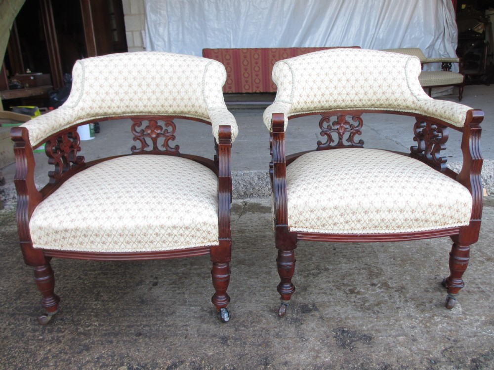 A five-piece antique mahogany parlour suite including a settee, two tub armchairs, and two side chairs with cream patterned upholstery and carved details. View XI