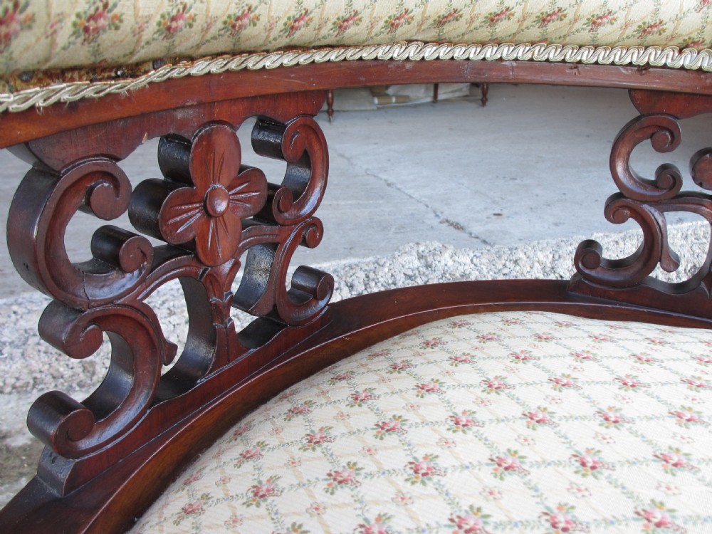 A five-piece antique mahogany parlour suite including a settee, two tub armchairs, and two side chairs with cream patterned upholstery and carved details. View XIV