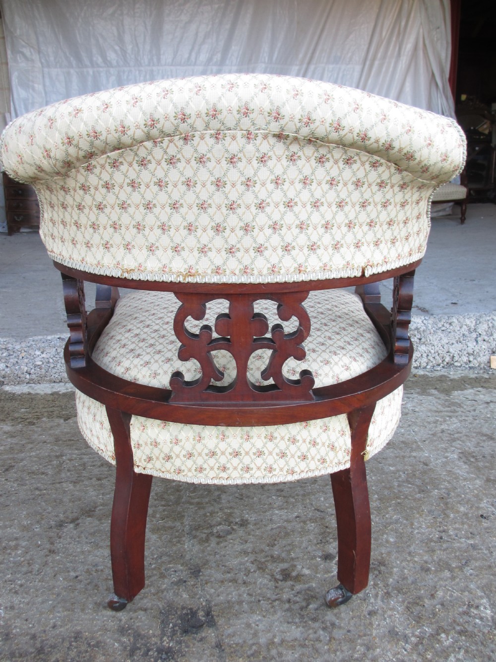A five-piece antique mahogany parlour suite including a settee, two tub armchairs, and two side chairs with cream patterned upholstery and carved details. View XVII
