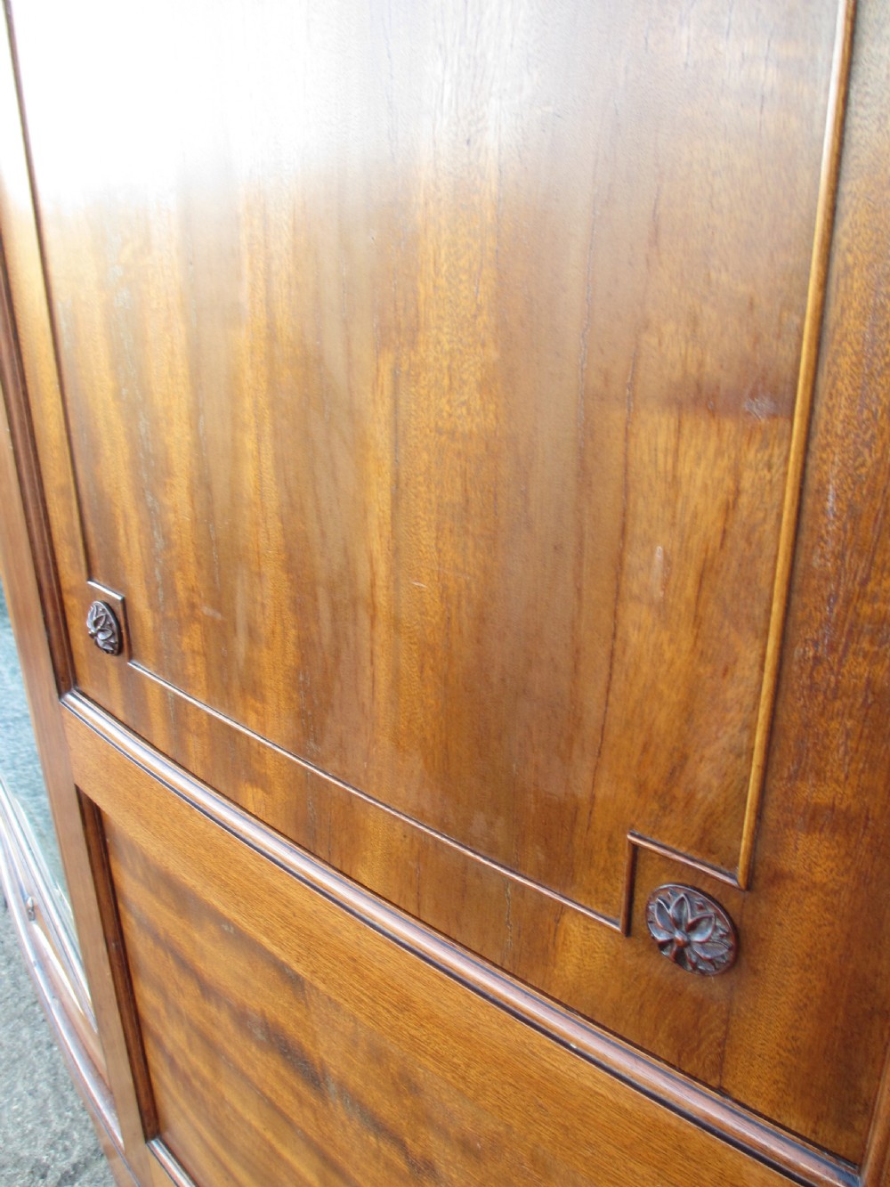 A Victorian bow-fronted mahogany triple wardrobe featuring a central full-length mirror door flanked by panelled flame mahogany doors. View VIII