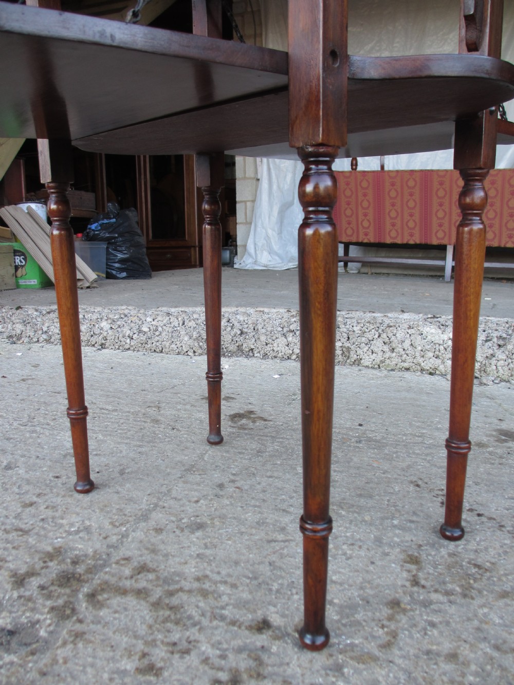 Victorian mahogany oval occasional table with lower shelf and fold-down side leaves held by metal chains. View VII
