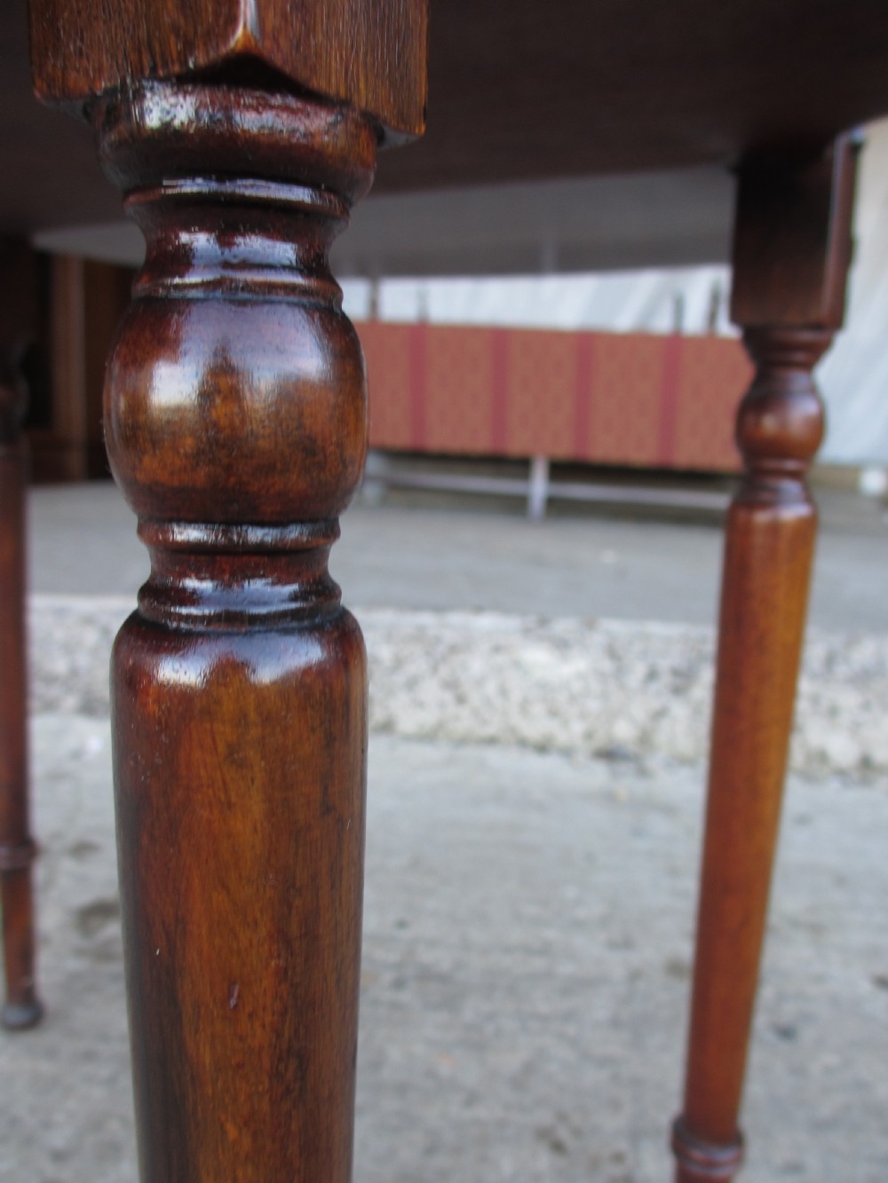 Victorian mahogany oval occasional table with lower shelf and fold-down side leaves held by metal chains. View VIII
