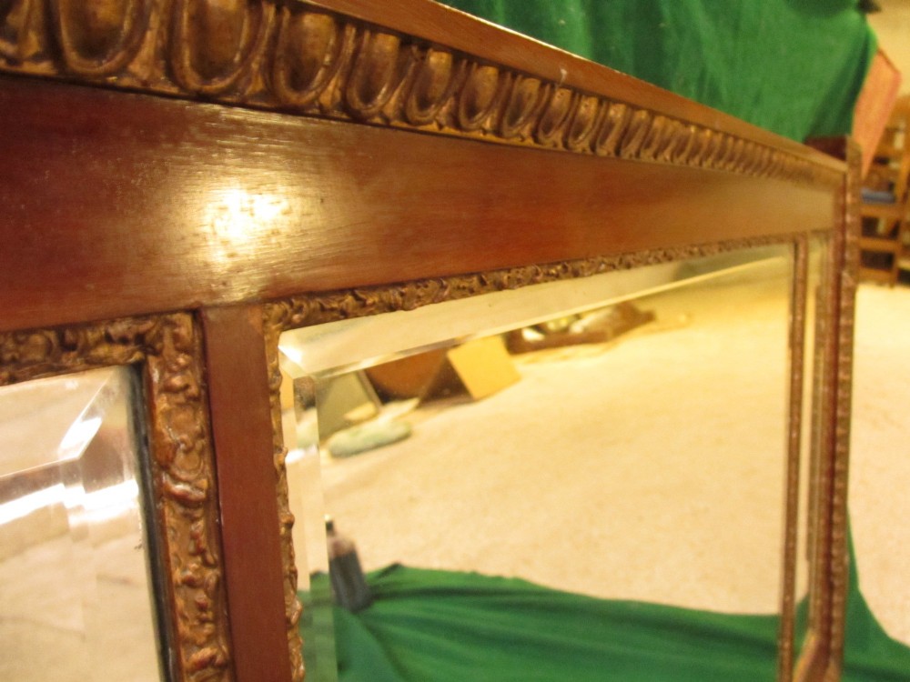 A horizontal 19th-century mahogany triple plate wall mirror featuring gilt egg-and-dart moulding along the frame with breakfront corner detailing. View V