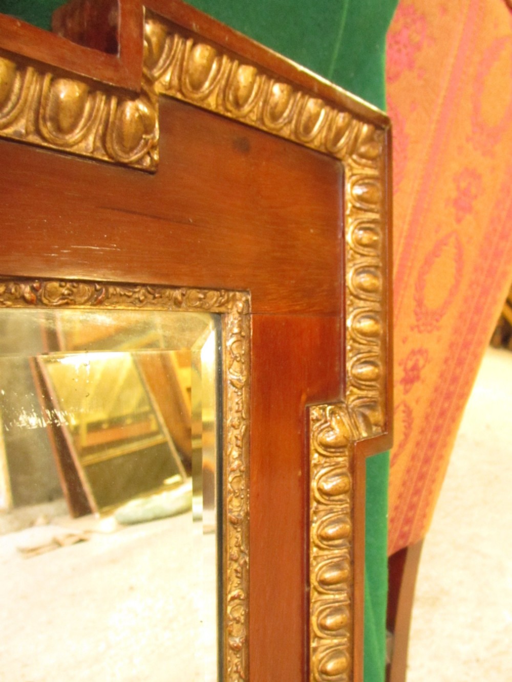 A horizontal 19th-century mahogany triple plate wall mirror featuring gilt egg-and-dart moulding along the frame with breakfront corner detailing. View VI