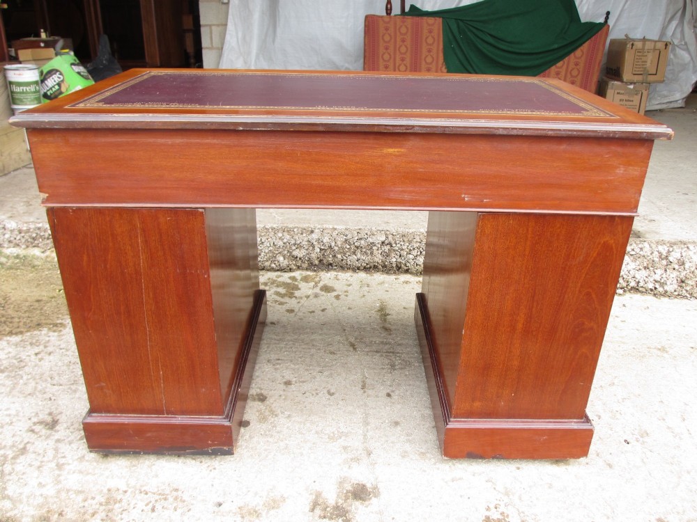 A Victorian walnut pedestal desk featuring nine drawers with brass drop handles and a maroon tooled leather inset writing surface. View XIV
