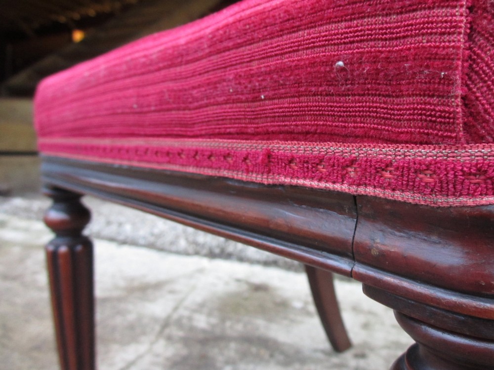 A set of six William IV mahogany dining chairs featuring curved top rails with flame mahogany veneer, reeded turned front legs, and red striped upholstered seats. View XI