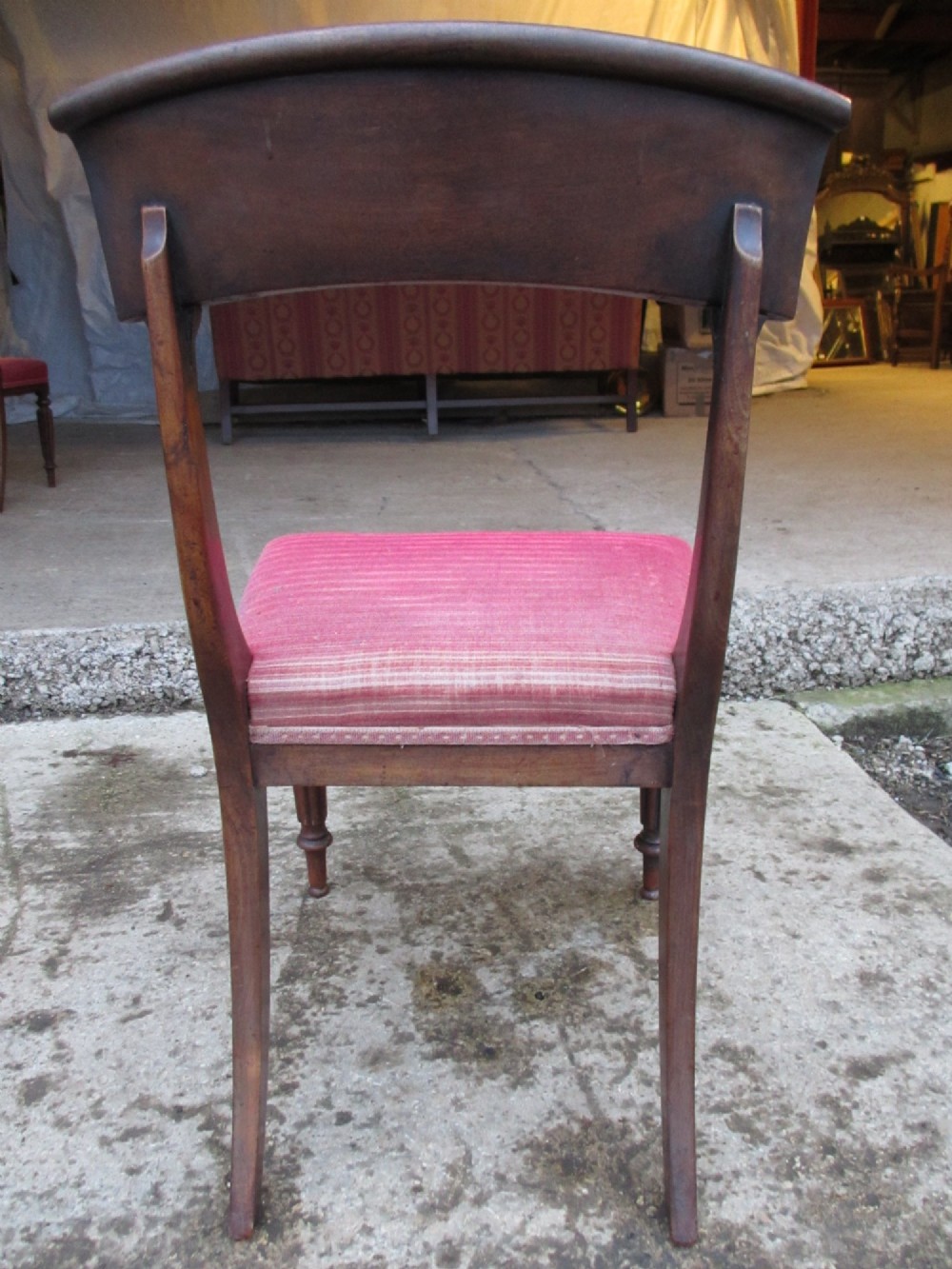 A set of six William IV mahogany dining chairs featuring curved top rails with flame mahogany veneer, reeded turned front legs, and red striped upholstered seats. View XV