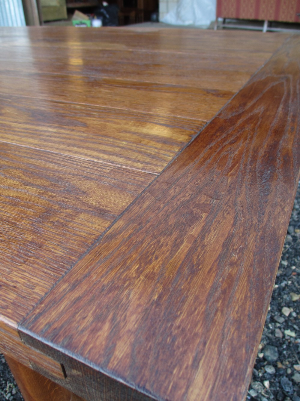 An eleven-foot oak refectory dining table with a planked top, low stretcher base, and heavy turned legs. View VI