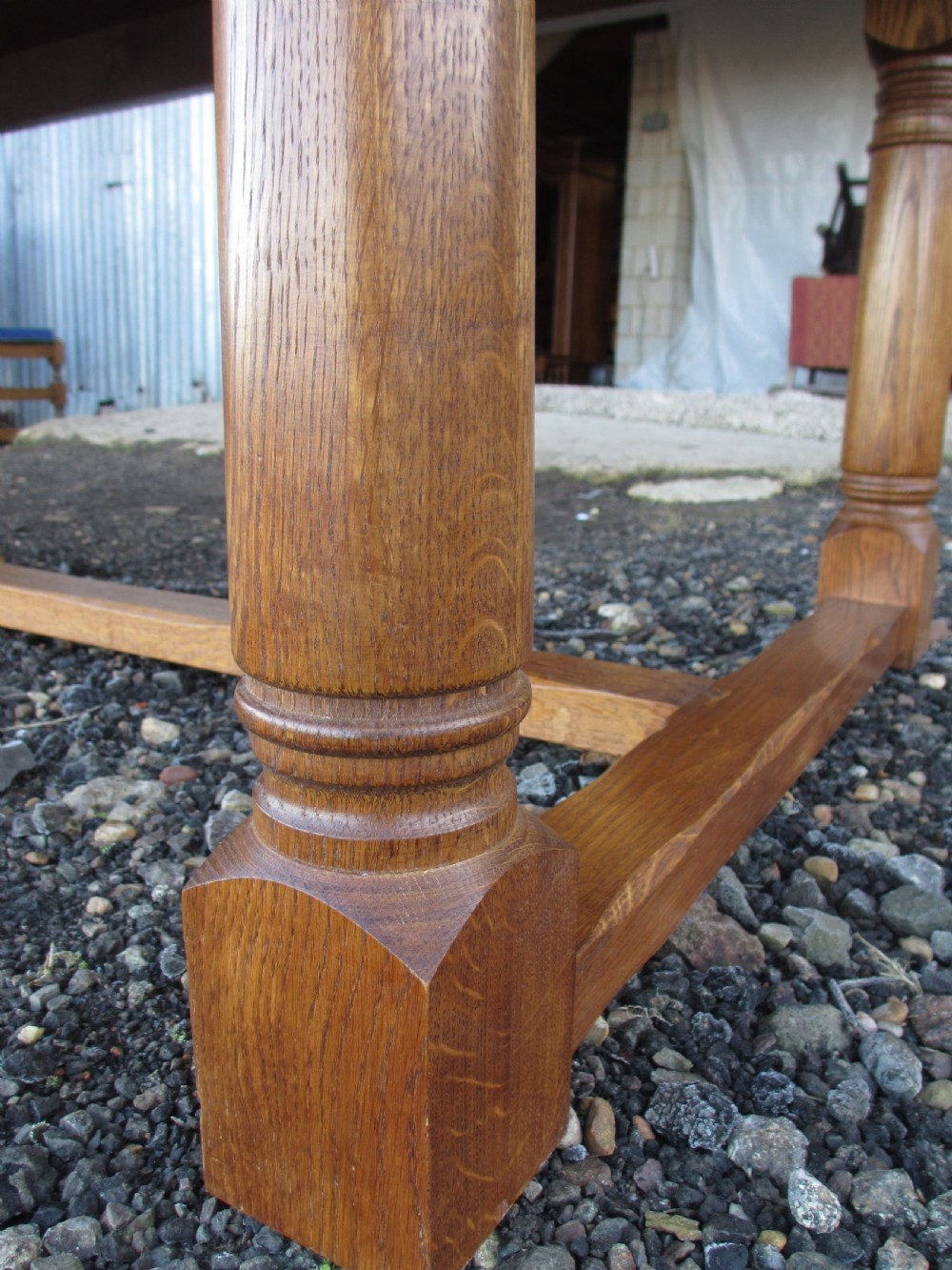 An eleven-foot oak refectory dining table with a planked top, low stretcher base, and heavy turned legs. View X