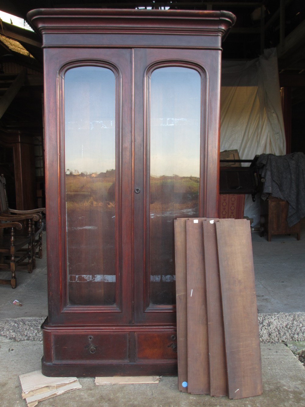 A tall 19th-century mahogany glazed bookcase featuring two long arched glass doors above a base fitted with two drawers. View XIV