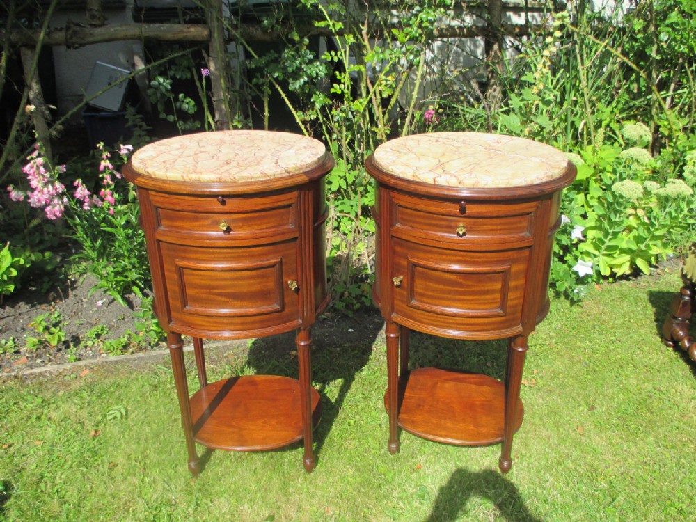 Pair of mahogany oval bedside tables