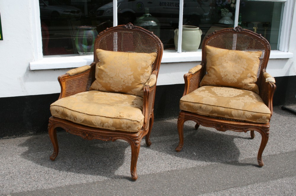pair of large caned bergere armchairs 